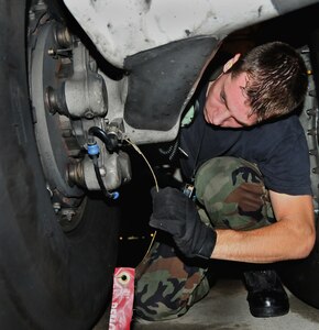 Senior Airman Marcus Williams inspects a proximity sensor target installed near the wheel of a C-17 here Aug. 27. Airman Williams installed the device while preparing for an operational checkout of the aircraft's landing gear. Airman Williams is a hyraulic systems journeyman with the 437th Aircraft Maintenance Squadron. (U.S. Air Force photo/Staff Sgt. Daniel Bowles)