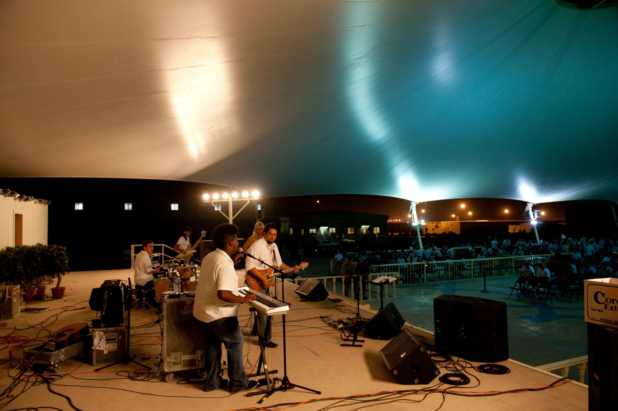 Night Shift, a southern California-based band, performs for military servicemembers, Aug. 31, in Southwest Asia. Night Shiftis the first U.S. band to perform here through the use of locally generated non-appropriated funds. Servicemembers are deployed in support of Operations Iraqi and Enduring Freedom. (U.S. Air Force photo/Staff Sgt. Robert Barney)
