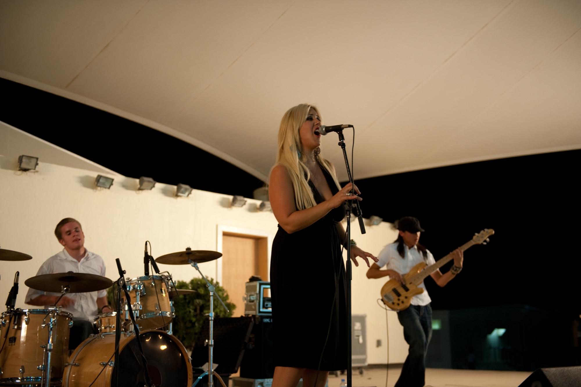 Savana Buttacavoli, Night Shift lead singer, performs for military servicemembers, Aug. 31, in Southwest Asia. Night Shift, a southern California-based band, is the first U.S. band to perform here through the use of locally generated non-appropriated funds. Servicemembers are deployed in support of Operations Iraqi and Enduring Freedom. (U.S. Air Force photo/Staff Sgt. Robert Barney)