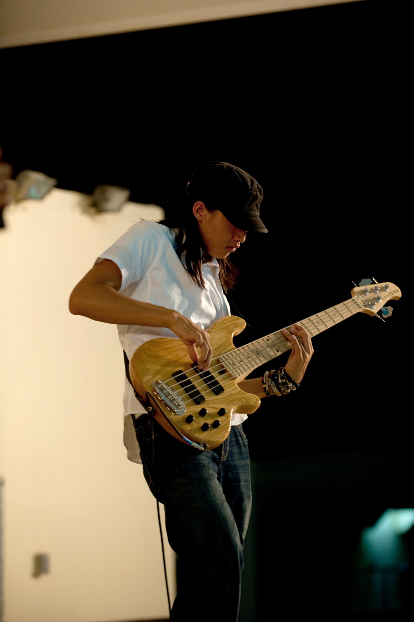 Derrick Wong, Night Shift bassist, performs for military servicemembers, Aug. 31, in Southwest Asia. Night Shift, a southern California-based band, is the first U.S. band to perform here through the use of locally generated non-appropriated funds. Servicemembers here are deployed in support of Operations Iraqi and Enduring Freedom. (U.S. Air Force photo/Staff Sgt. Robert Barney)