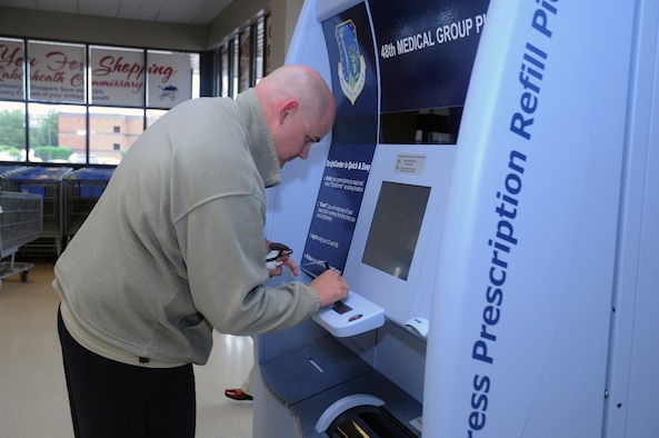 Tech. Sgt. Ryan Soens, 48th Civil Engineer Squadron, picks up prescription medication refills for the first time at the new ScriptCenter in the RAF Lakenheath Commissary on Sept. 2, 2009. The ScriptCenters were set up to decrease the traffic at the pharmacy and increase customer convenience by expanding refill pick-up time to that of the commissary hours. (U.S. Air Force photo/Senior Airman Kristopher Levasseur) 