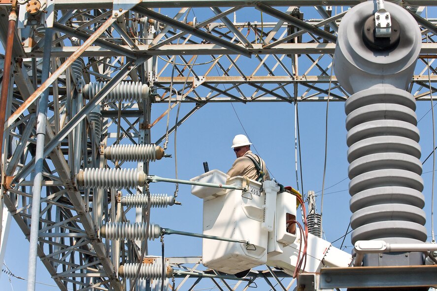 Chris Vinson, City of Dover electric technician, works to replace a part that failed at an electrical substation Aug. 27, causing Dover Air Force Base to lose power for more than two hours. The failure caused the breakers on the substation to short out, cutting power to the base and some surrounding neighborhoods. (U.S. Air Force photo/Roland Balik)