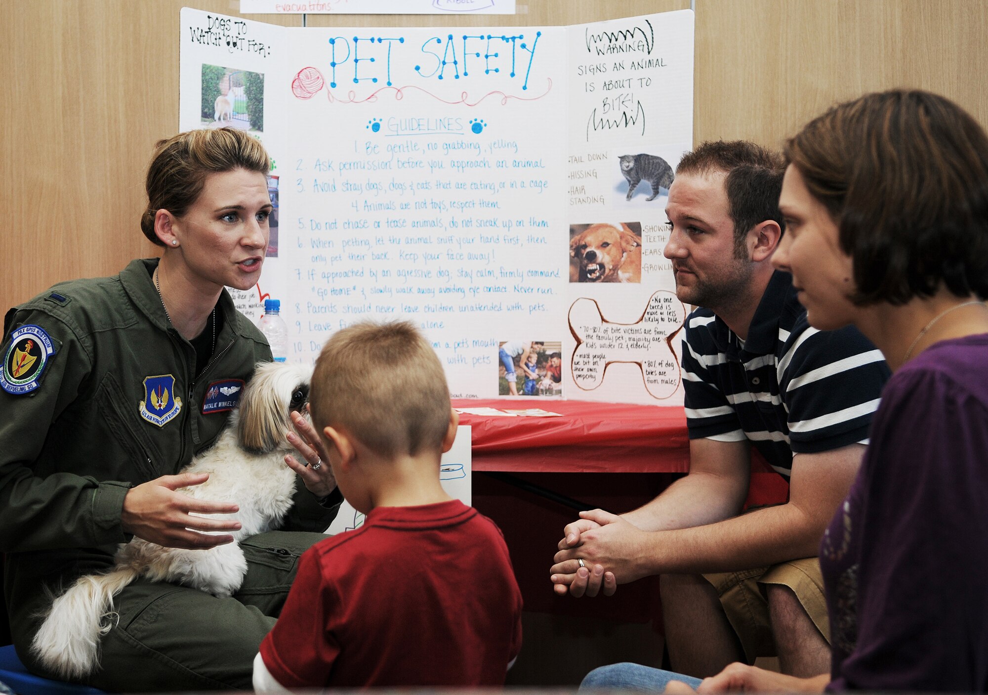 RAF MILDENHALL, England -- First Lt. Natalie Winkels, 351st Air Refueling Squadron (left), and her husband Jon run a pet safety information booth at a Kids' Safety Day event hosted by the American Red Cross Aug. 27 at the Bob Hope Community Center. Becky Barner, military spouse, has lived at Mildenhall for a week and visited the fair with her sons Jacob, 2, and Luke, 1 (not pictured). The safety day covered items such as fire safety, first aid kits and blood safety. (U.S. Air Force photo/Senior Airman Thomas Trower)