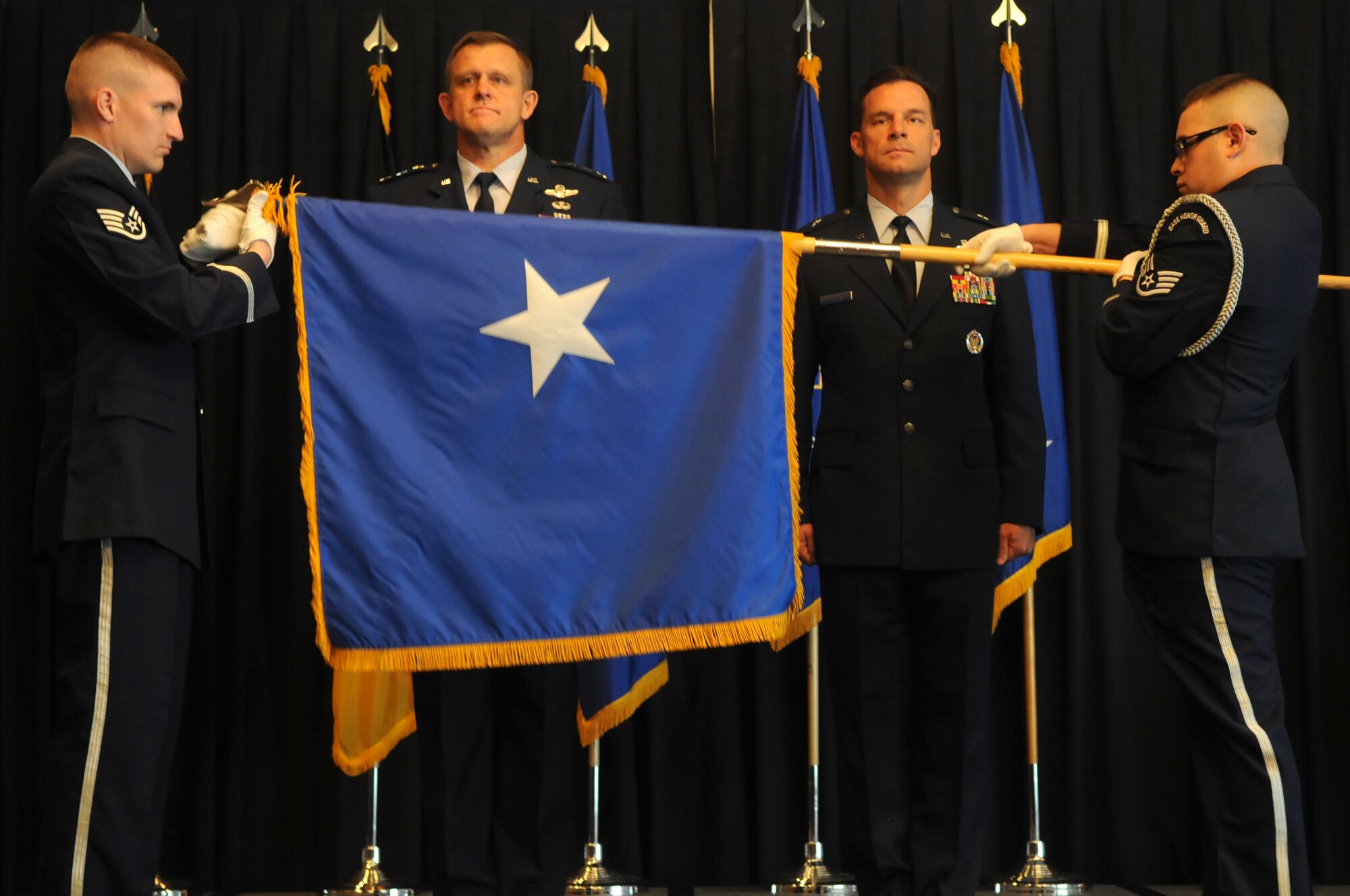 Lt. Gen. Frank Gorenc, 3rd Air Force commander, and Brig. Gen. Mark Dillon, 86th Airlift Wing commander, prepare to receive the one-star flag from members of the Ramstein Air Base Honor Guard. General Dillon was promoted to the rank of brigadier general during a ceremony at the Officer's Club on Ramstein Sept. 2. (U.S. Air Force photo by Staff Sgt. Charity Barrett)