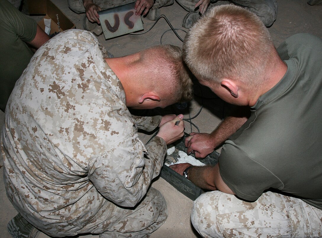 U.S. Marines prepare improvised Claymore mines during a combat engineer demolition course at a training area near Camp Buehring, Kuwait, Aug. 27, 2009. The Marines are assigned to Battalion Landing Team, 3rd Battalion, 2nd Marine Regiment, 22nd Marine Expeditionary Unit. The unit is conducting sustainment training in Kuwait while serving as the reserve force for U.S. Central Command.