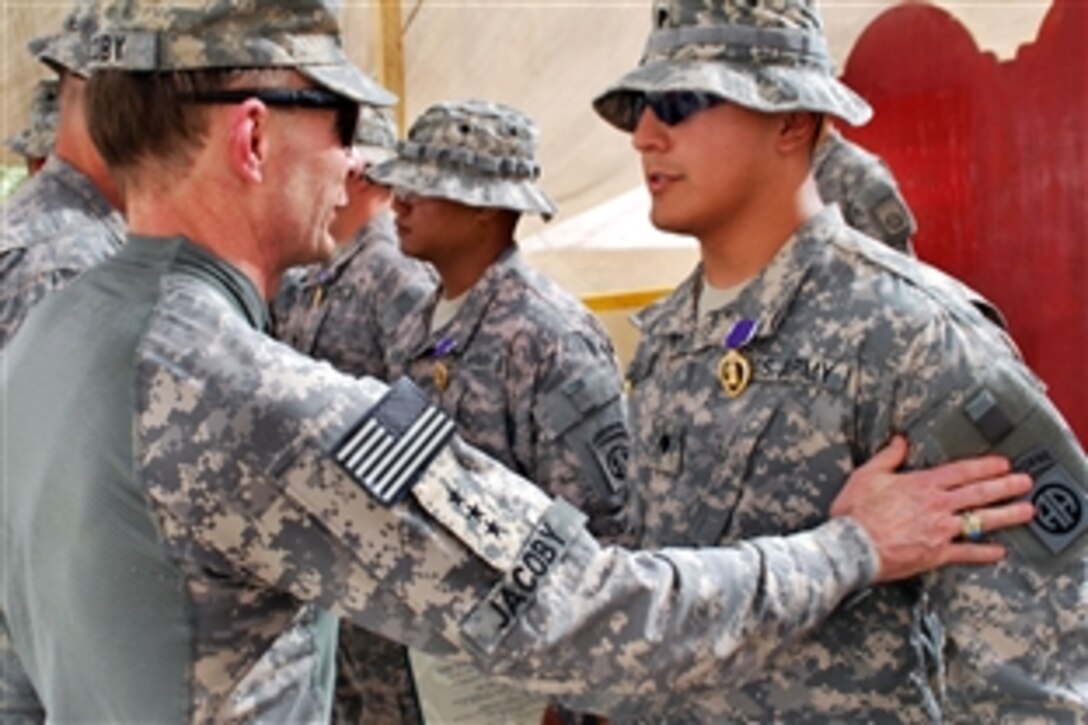 U.S. Army Lt. Gen. Charles H. Jacoby thanks Spc. David De La Rosa for his sacrifice and service after awarding him the Purple Heart medal on Combat Outpost Cashe South, Iraq, Sept. 1, 2009. Jacoby is the commanding general of Multinational Corps Iraq. De La Rosa, injured in a blast from an improvised explosive device during a combat operation May 17, is assigned to the 82nd Airborne Division's Troop B, 5th Squadron, 73rd Cavalry Regiment, 3rd Brigade Combat Team.     
