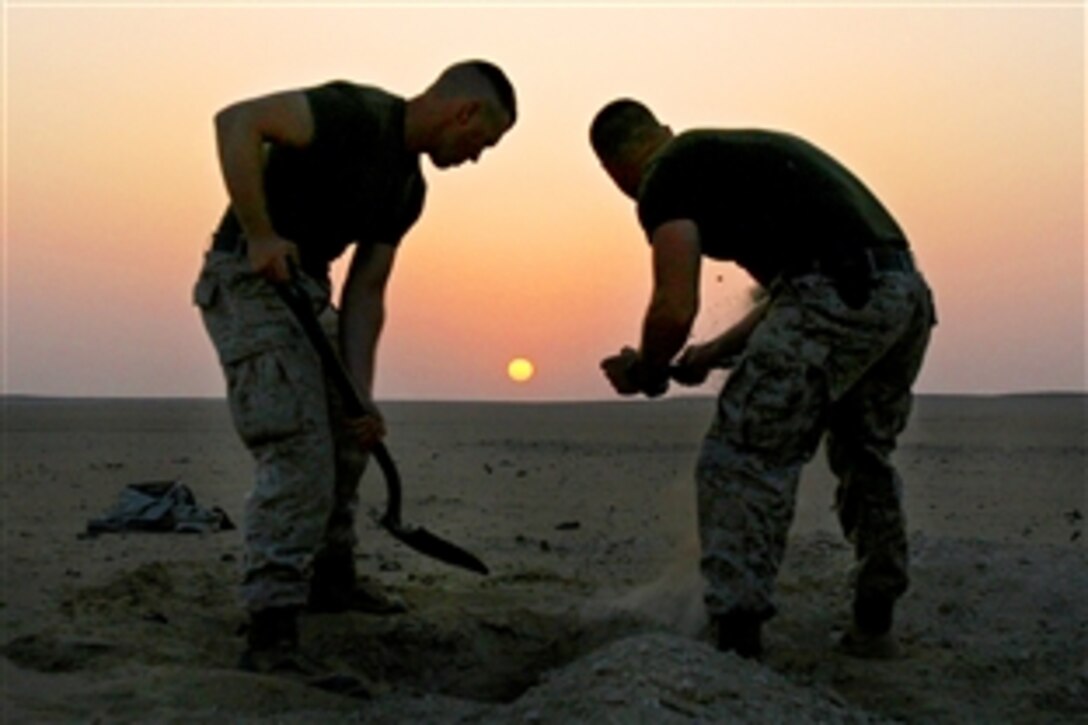 U.S. Marines dig holes for a 55-gallon improvised flame mine during a combat engineer demolition course at a training area near Camp Buehring, Kuwait, Aug. 27, 2009. The Marines are assigned to Battalion Landing Team, 3rd Battalion, 2nd Marine Regiment, 22nd Marine Expeditionary Unit. The unit is conducting sustainment training in Kuwait while serving as the reserve force for U.S. Central Command.