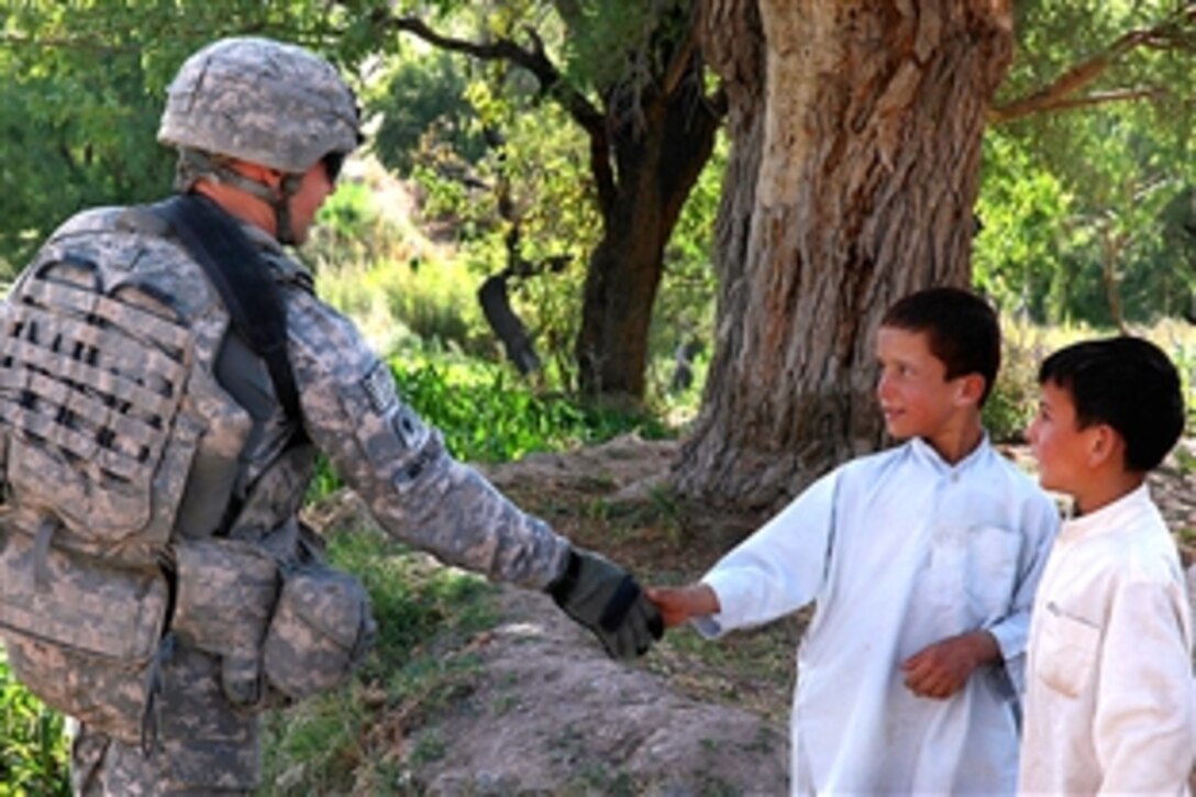 U.S. Army Spc. Brandon Masters greets Afghan children while patrolling in Logar province, Afghanistan, Aug. 26, 2009. Masters is assigned to the 10th Mountain Division's 710th Brigade Support Battalion, 3rd Battaltion.
