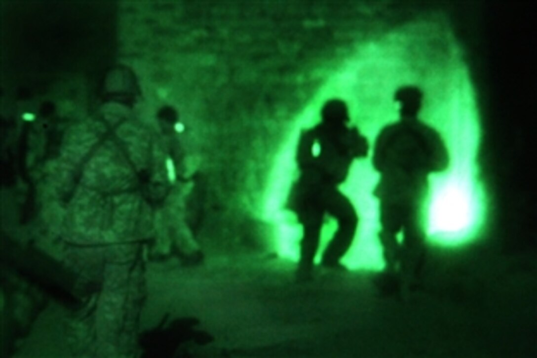 As seen through a night-vision device, coalition forces and Afghan commandos cordon and search a compound during Operation Raven for an improvised explosive device cell operating in the area east of Khowst City, Afghanistan, Aug. 31, 2009.