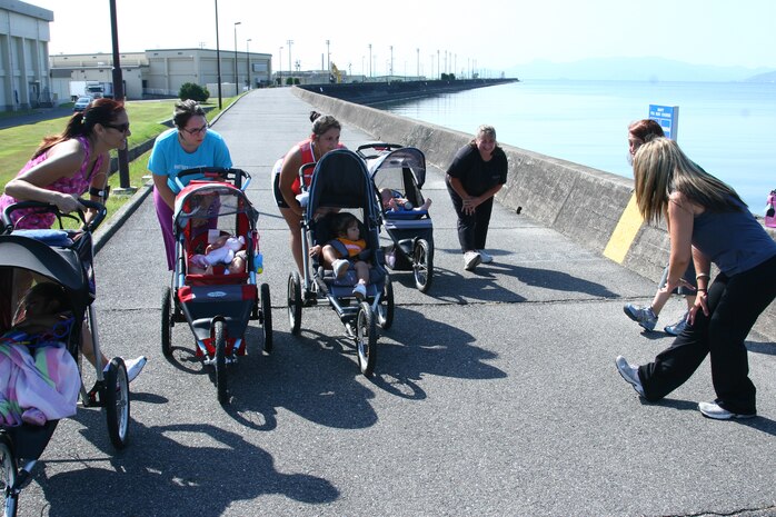 Stroller Fit participants perform cool down stretches to end class Sept. 2.