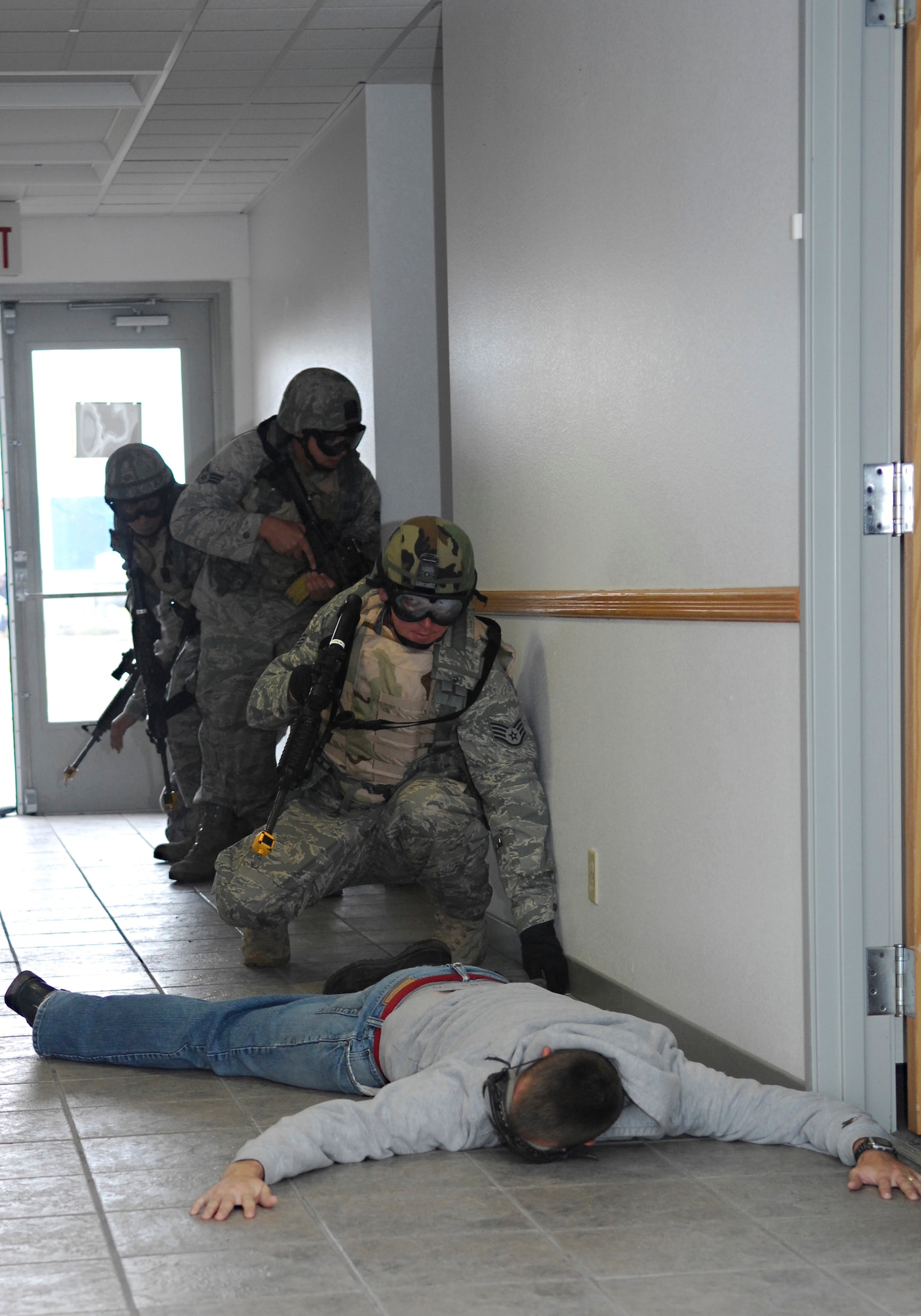 VANDENBERG AIR FORCE BASE, Calif. -- Using their newly-learned take-down techniques, Airmen of the 30th Security Forces Squadron apprehend a suspect during training here Aug. 18. Each of the squadron's four flights attend monthly training sessions to learn new skills critical  to their job performance.  (U.S. Air Force photo/Airman 1st Class Heather R. Shaw)