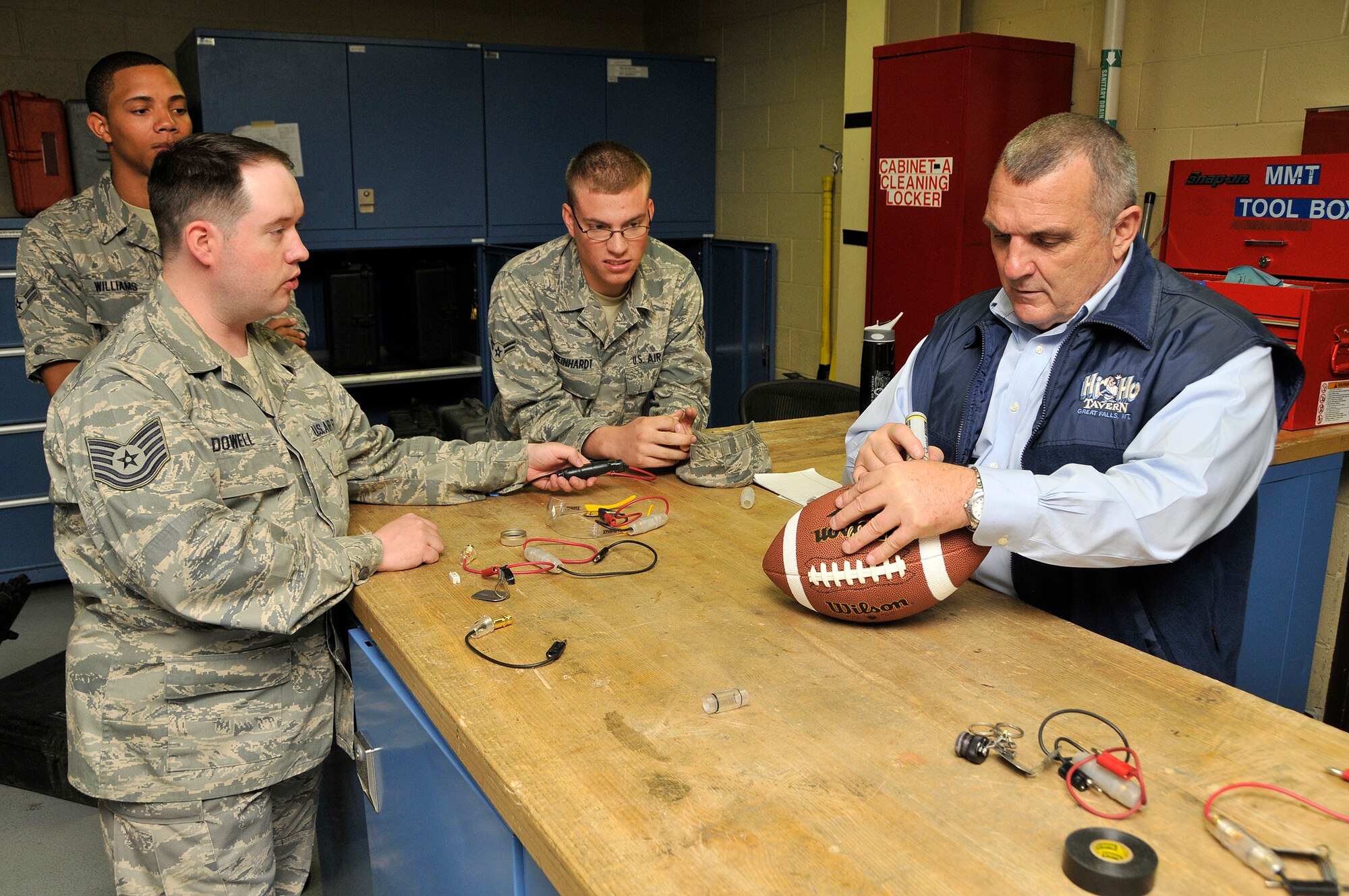 Mr. Daniel "Rudy" Ruettiger, a Notre Dame football legend and the real life inspiration for the feature film "Rudy", signs autographs for Airmen of the 341st Maintenance Group during his tour of Malmstrom Air Force Base Aug. 28. (U.S. Air Force photo/John Turner)