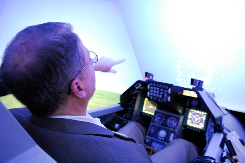 State Rep. Frank Corte, Jr., of San Antonio, simulates flight in an F-16 trainer at the Texas Air National Guard's 149th Fighter Wing at Lackland Air Force Base, Texas, on August 28, 2009. (U.S. Air Force photo/Senior Master Sgt Mike Arellano)