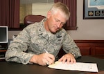 Col. William H. Mott V, 37th Training Wing commander, fills out a Combined Federal Campaign contribution form Sept. 1. The campaign kicked off Sept. 2 and runs until Oct. 14. The CFC raises money each year for local, national and international charities. (U.S. Air Force photo/Robbin Cresswell) 