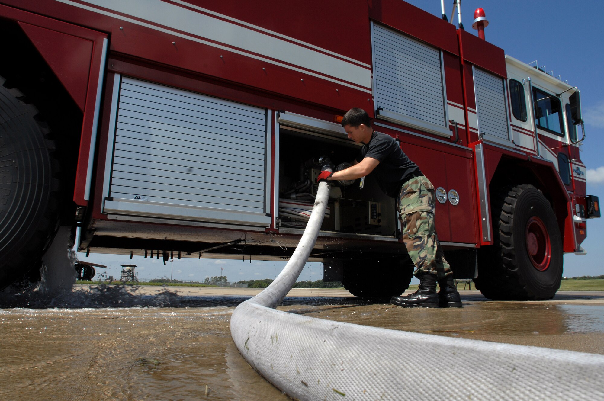 WHITEMAN AIR FORCE BASE, Mo. - Airman 1st Class Brian Wiggins, 509th Civil Engineer Squadron firefighter, disconnects a hose from a squadron fire truck during an aircraft live-burn exercise, Sept. 2. Several enlisted and civilian firefighters participated in the simulated fire to keep their qualifications and skills up-to-date. The exercise is conducted once a year, and firefighters are put into several different scenarios where they are forced to react quickly and accurately. (U.S. Air Force photo/Senior Airman Kenny Holston)