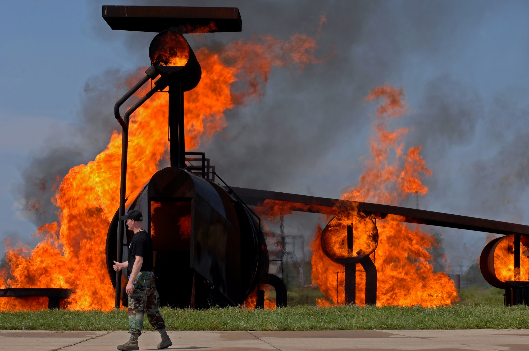 WHITEMAN AIR FORCE BASE, Mo. - Senior Airman Bryan Daspit, 509th Civil Engineer Squadron firefighter, gives the thumbs up to begin training after getting the aircraft training structure lit, Sept. 2. Enlisted and civilian firefighters battled hot flames for several hours during training in an effort to keep their qualification and skill up-to-date. The exercise is conducted once a year, and firefighters are put into several different scenarios where they are forced to react quickly and accurately. (U.S. Air Force photo/Senior Airman Kenny Holston)
