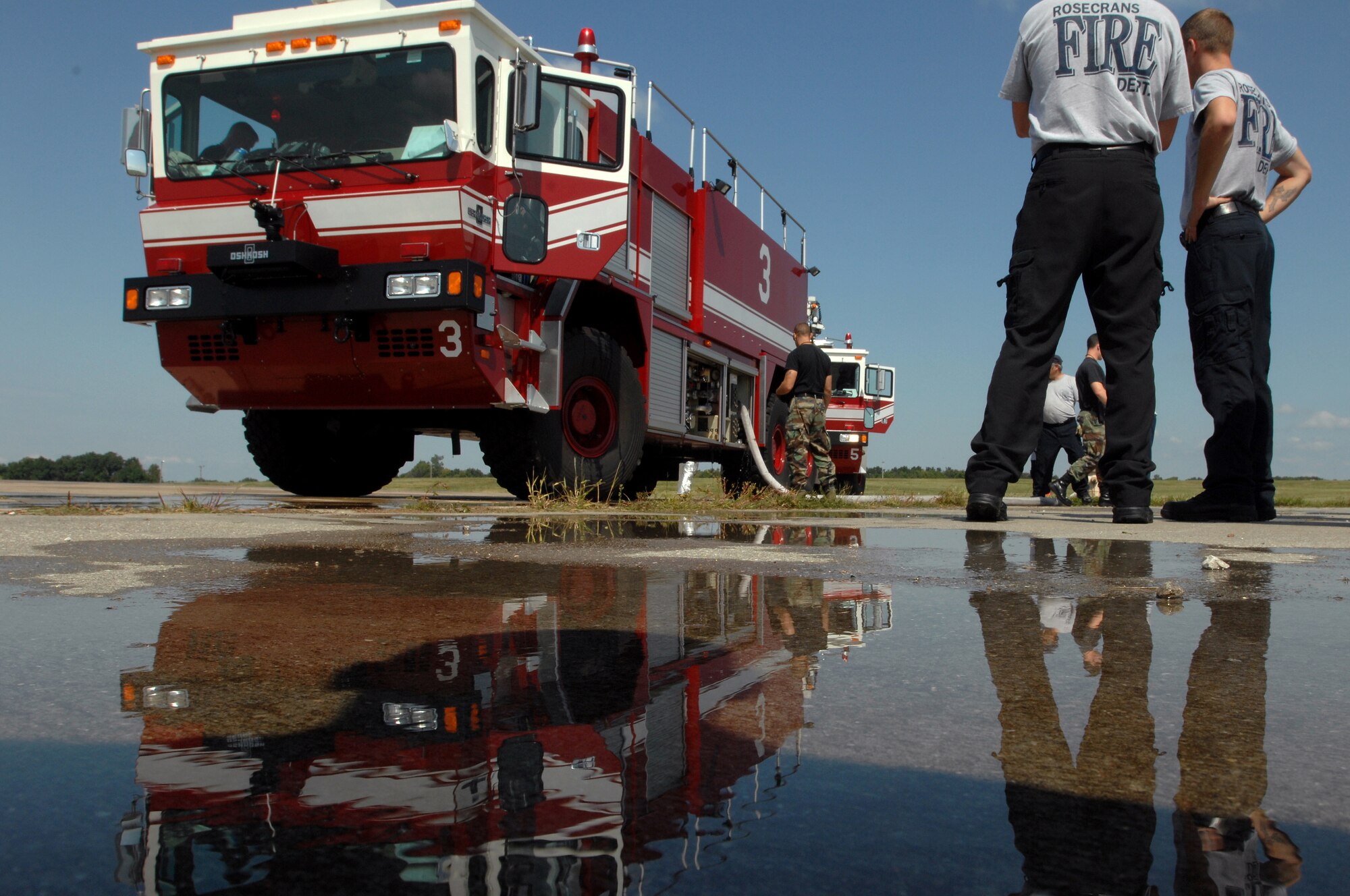 WHITEMAN AIR FORCE BASE, Mo. - Firefighters with the 509th Civil Engineer Squadron, gear up in preparation for a training exercise, Sept. 2. Enlisted and civilian firefighters battled hot flames for several hours during training in an effort to keep their qualification and skill up-to-date. The exercise is conducted once a year, and firefighters are put into several different scenarios where they are forced to react quickly and accurately. (U.S. Air Force photo/Senior Airman Kenny Holston)