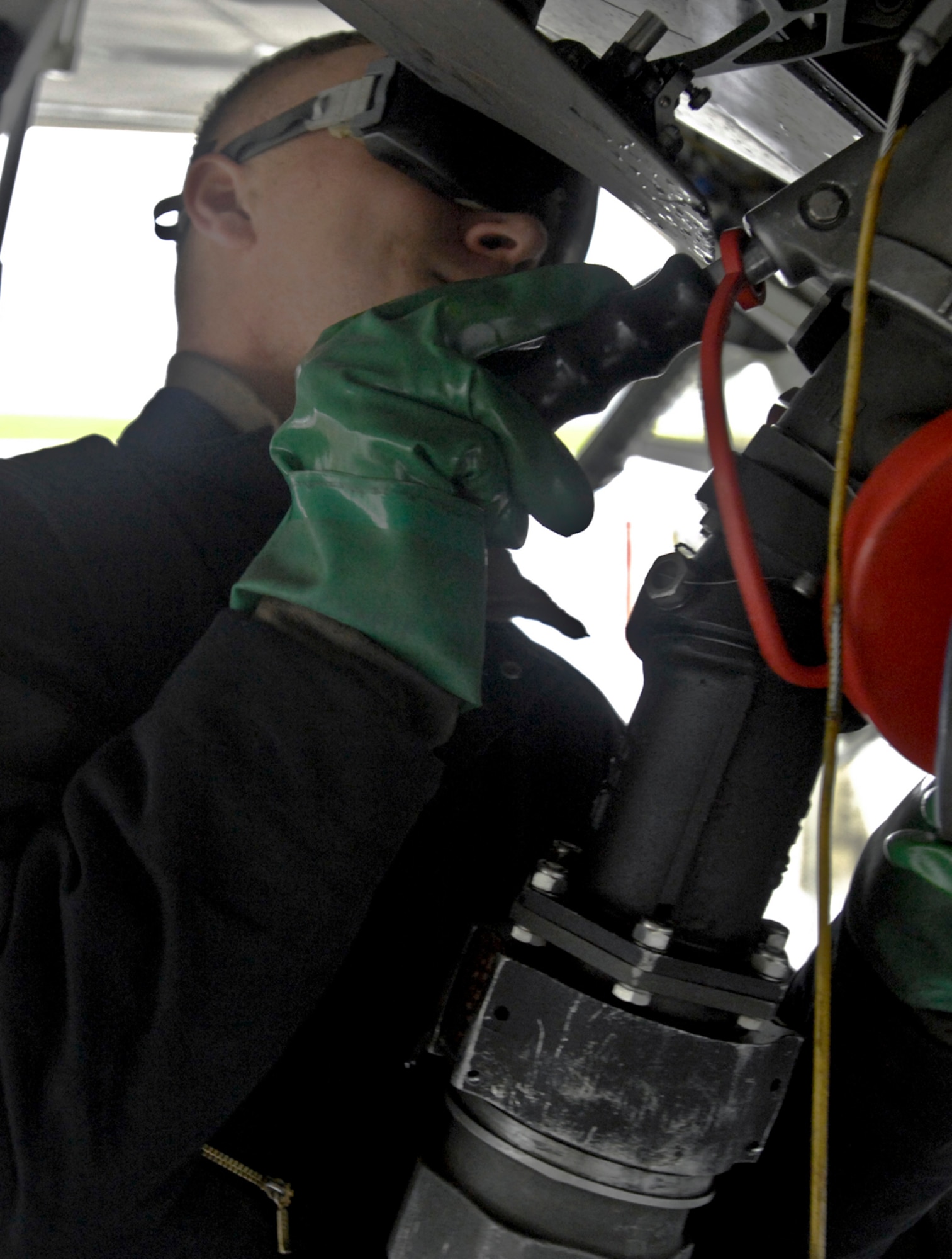 ELMENDORF AIR FORCE BASE, Alaska -- Airman 1st Class Alexander Chisholm,  525th Aircraft Maintenance Unit, hooks up a fuel hose to an F-22 Raptor Sept. 1. Elmendorf began the using  Plus 100 additive in their JP-8 aviation fuel Sept. 1. The additive helps prevent buildup in F-15 Eagle and F-22 Raptor engines; therefore it will reduce the amount of maintenance needed on those engines.    (U.S. Air Force photo/Airman 1st Class Christopher Gross)

