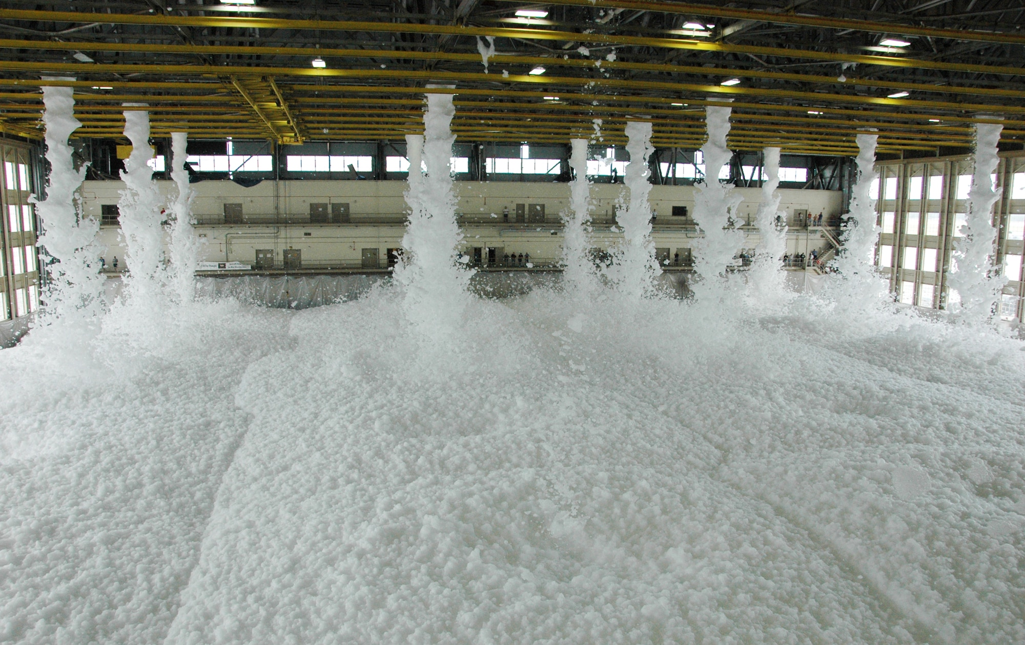 Approximately 110 gallons of biodegradable foam poured from the ceiling of King Hangar Sept. 3 at Eglin Air Force Base during the final test of the new fire suppression system.  It took only two minutes for the 24 foam generators to fill the 90,000 square foot hangar with more than three feet of foam.  This was part of an ongoing process to update the historic Eglin icon.  (U.S. Air Force photo/Airman 1st Class Chris Jacobs.)