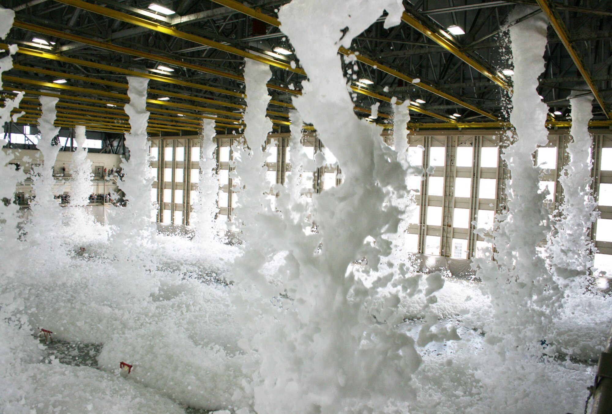 Approximately 110 gallons of biodegradable foam poured from the ceiling of King Hangar Sept. 3 at Eglin Air Force Base during the final test of the new fire suppression system.  It took only two minutes for the 24 foam generators to fill the 90,000 square foot hangar with more than three feet of foam.  This was part of an ongoing process to update the historic Eglin icon.  (U.S. Air Force photo/2nd Lt. Andrew Caulk.)