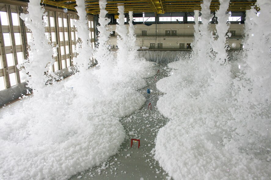 Approximately 110 gallons of biodegradable foam poured from the ceiling of King Hangar Sept. 3 at Eglin Air Force Base during the final test of the new fire suppression system.  It took only two minutes for the 24 foam generators to fill the 90,000 square foot hangar with more than three feet of foam.  This was part of an ongoing process to update the historic Eglin icon.  (U.S. Air Force photo/2nd Lt. Andrew Caulk.)