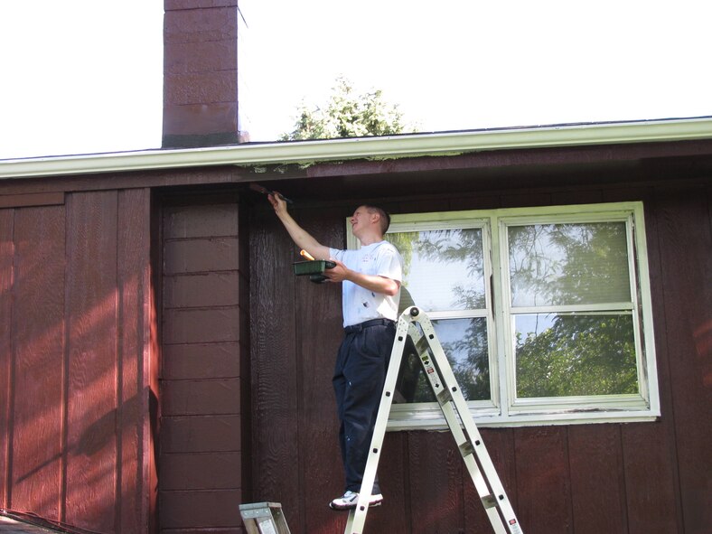 BELLEVUE, Neb. -- Maj. Christopher A. Schwartz, 45th Reconnaissance Squadron, paints the underside of the roof of a house in Bellevue, Neb. Aug. 22 during the 21st annual Brush Up Nebraska Paint-A-Thon. The annual event started in Sept. 1989, since then more than 2,000 homes have been painted. U.S. Air Force Photo by Master Sgt. Kevin Pawlik