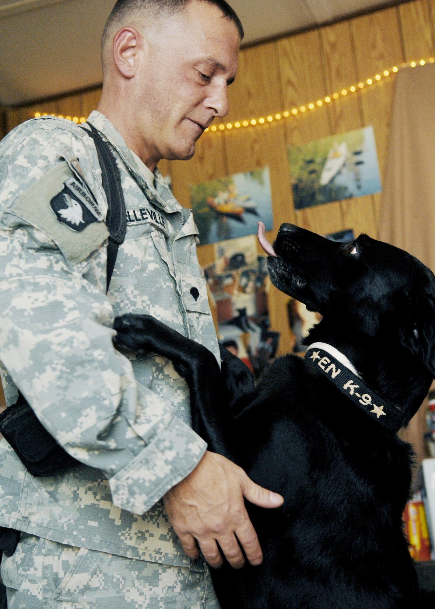 Army Spc. Chris Belville spends time with his canine, Cookie, in his living quarters Aug. 28, 2009, at Joint Base Balad, Iraq. Specialist Belville is a 25th Infantry Division dog handler. (U.S. Air Force photo/Senior Airman Christopher Hubenthal) 