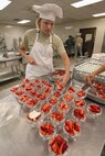 Airman 1st Class Stephanie Semrau, a student at the at Lackland's Culinary Arts Training Center, prepares a strawberry dessert for lunch. (U.S. Air Force photo/Robbin Cresswell)