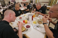 Air Force Basic Military Training trainees from Lackland's 320th Training Squadron eat breakfast before going out to the drill pad for parade practice. (U.S. Air Force photo/Robbin Cresswell)