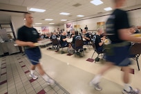 Airman with Lackland's 320th Training Squadron, Flight 457, eat breakfast before going out to the drill pad for parade practice. (U.S. Air Force photo/Robbin Cresswell)