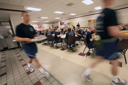 Airman with Lackland's 320th Training Squadron, Flight 457, eat breakfast before going out to the drill pad for parade practice. (U.S. Air Force photo/Robbin Cresswell)