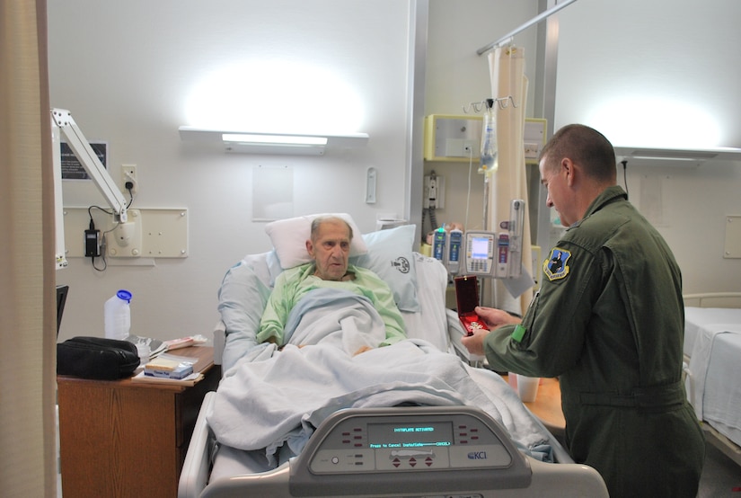Lt. Col. Gordon Smith, a paratrooper from WWII, shows Major General Michael Dubie, Adjutant General of the State of Vermont, the French National Order of the Legion of Honour at Landstuhl Army Regional Medical Center, Landstuhl, Germany, June 17. Colonel Smith received the medal on behalf of all paratroopers who jumped over Normandy on June 6, 1944.  The Order was established by Napoleon Bonaparte in 1802 and is France’s highest decoration. (Air Force photo/Capt Bryan Lewis)