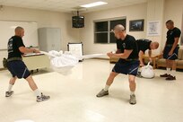 Air Force Basic Military Training trainees with Lackland's 320th Training Squadron secure linen for the laundry before dorm room for inspection. (U.S. Air Force photo/Robbin Cresswell)