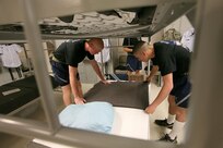 Air Force Basic Military Training trainees with Lackland's 320th Training Squadron, Flight 457, prepare a bed for dorm room for inspection. (U.S. Air Force photo/Robbin Cresswell)