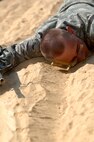 An Air Force Basic Military Training trainee demonstrates low crawling during combat skills training. (U.S. Air Force photo/Senior Airman Nicole Roberts) 