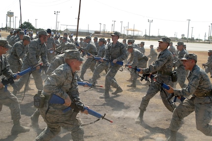 Air Force Basic Military Training trainees from Lackland's 326th Training Squadron  demonstrate different tactical positions during combat skills training. Trainees are familiarized with combat maneuvers during BMT to better prepare them for future deployments.  (U.S. Air Force photo/Senior Airman Nicole Roberts) 