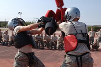 Trainees from Lackland's 326th Training Squadron face off in a pugil stick fighting match. The pugil stick fighting portion of Air Force Basic Military Training is held during the 5 WOT and helps teach basic self defense techniques. (U.S. Air Force photo/Senior Airman Nicole Roberts) 