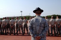 Tech. Sgt. Daniel Wright, a military training instructor from Lackland's 342nd Training Squadron, looks on as trainees partner up before the pugil stick fighting matches. (U.S. Air Force photo/Senior Airman Nicole Roberts) 