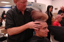 An Air Force Basic Military Training trainee from Lackland's 331st Training Squadron recieves his first hair cut at BMT. Trainee's recieve thieir first haircut during zero week, the first week of BMT. (U.S. Air Force photo/Senior Airman Nicole Roberts)  