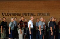 After their first haircuts, Air Force Basic Military Training trainees from Lackland's 331st Training Squadron stand at attention while waiting for their clothing intial issue. Trainee's are fitted for thier uniforms and are issued physical training gear while at clothing intial issue during zero week, the first week they spend in BMT.  (U.S. Air Force photo/Senior Airman Nicole Roberts)  