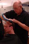 An Air Force Basic Military Training trainee from Lackland's 331st Training Squadron recieves his first hair cut at BMT. Trainee's recieve their first haircut during zero week, the first week they spend BMT. (U.S. Air Force photo/Senior Airman Nicole Roberts)  