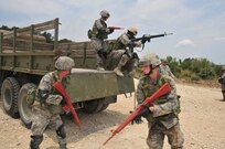 Security forces students exit a Humvee during basic combat convoy field training at Camp Bullis. Camp Bullis, a training camp located in northwest San Antonio, is used primarily as maneuvering grounds for Army, Air Force and Marine combat units. (U.S. Air Force photo/Patrick Nugent) 