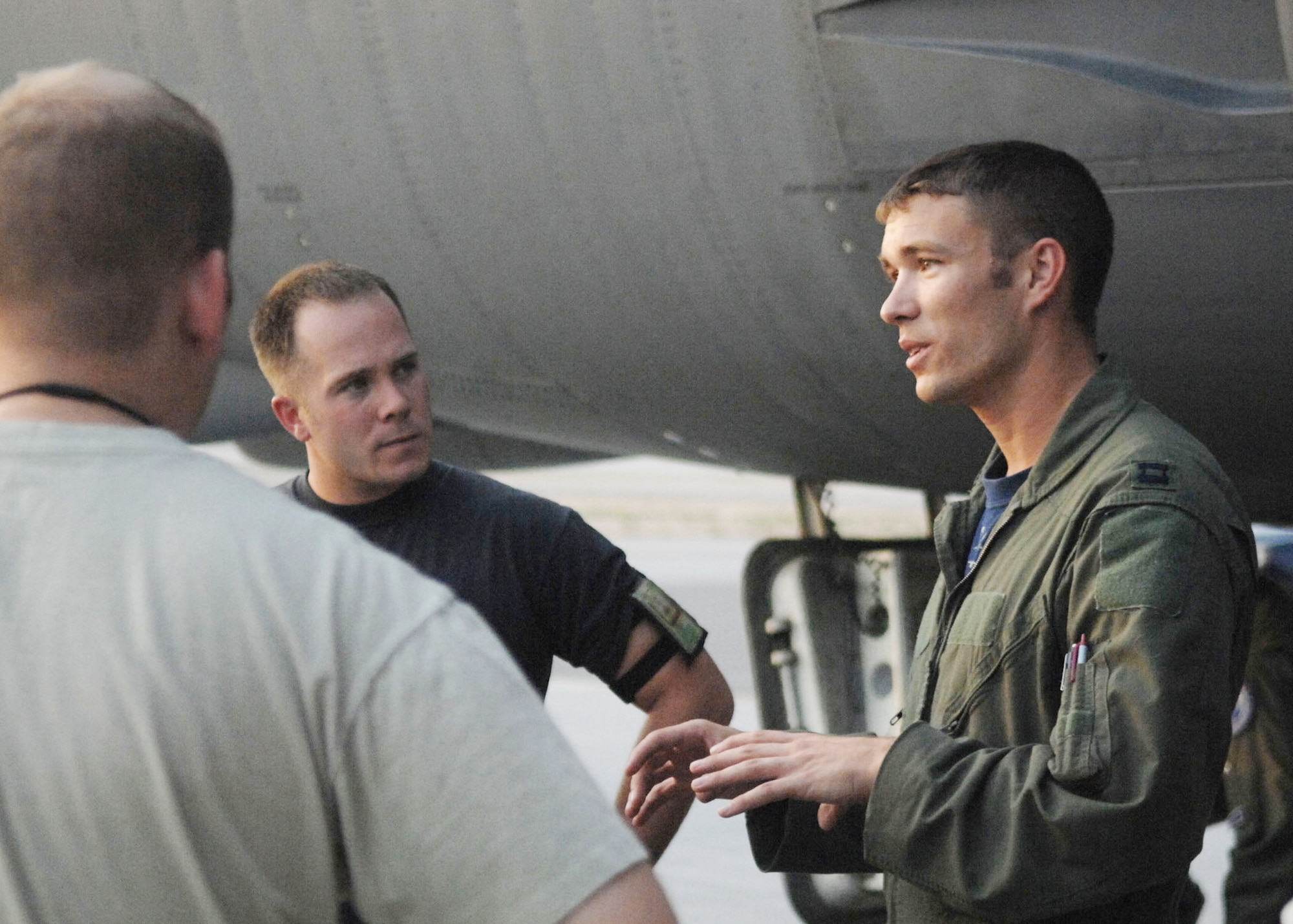 Staff Sgt. Sean Adkins listens as Capt. Warren Carroll conducts a post-flight maintenance brief with maintainers Aug. 21, 2009 after arriving at Nellis Air Force Base, Nev. Captain Carroll is assigned to the 20th Bomb Squadron at Barksdale AFB, La. Sergeant Adkins is assigned to the 2nd Maintenance Squadron at Barksdale AFB. (U.S. Air Force photo/Staff Sgt. Sarah Stegman)