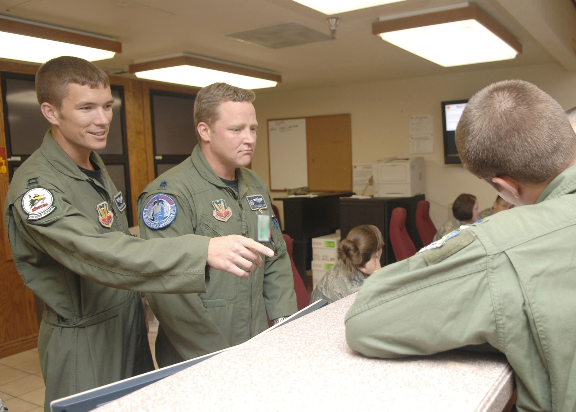 Capt. Warren Carroll and Lt. Col. Tyrell Chamberlain man the operations desk at Red Flag 09-5 Aug. 26, 2009 at Nellis Air Force Base, Nev. Colonel Chamberlain is the acting mission director for day and Captain Carroll is shadowing the colonel for training. Red Flag is an intense two-week combat scenario exercise where flyers integrate with other airframes and units to perform at large force employment. Colonel Chamberlain is the 20th Bomb Squadron commander at Barksdale AFB, La. Captain Carroll is a pilot assigned to the 20th Bomb Squadron. (U.S. Air Force photo/Staff Sgt. Sarah Stegman)