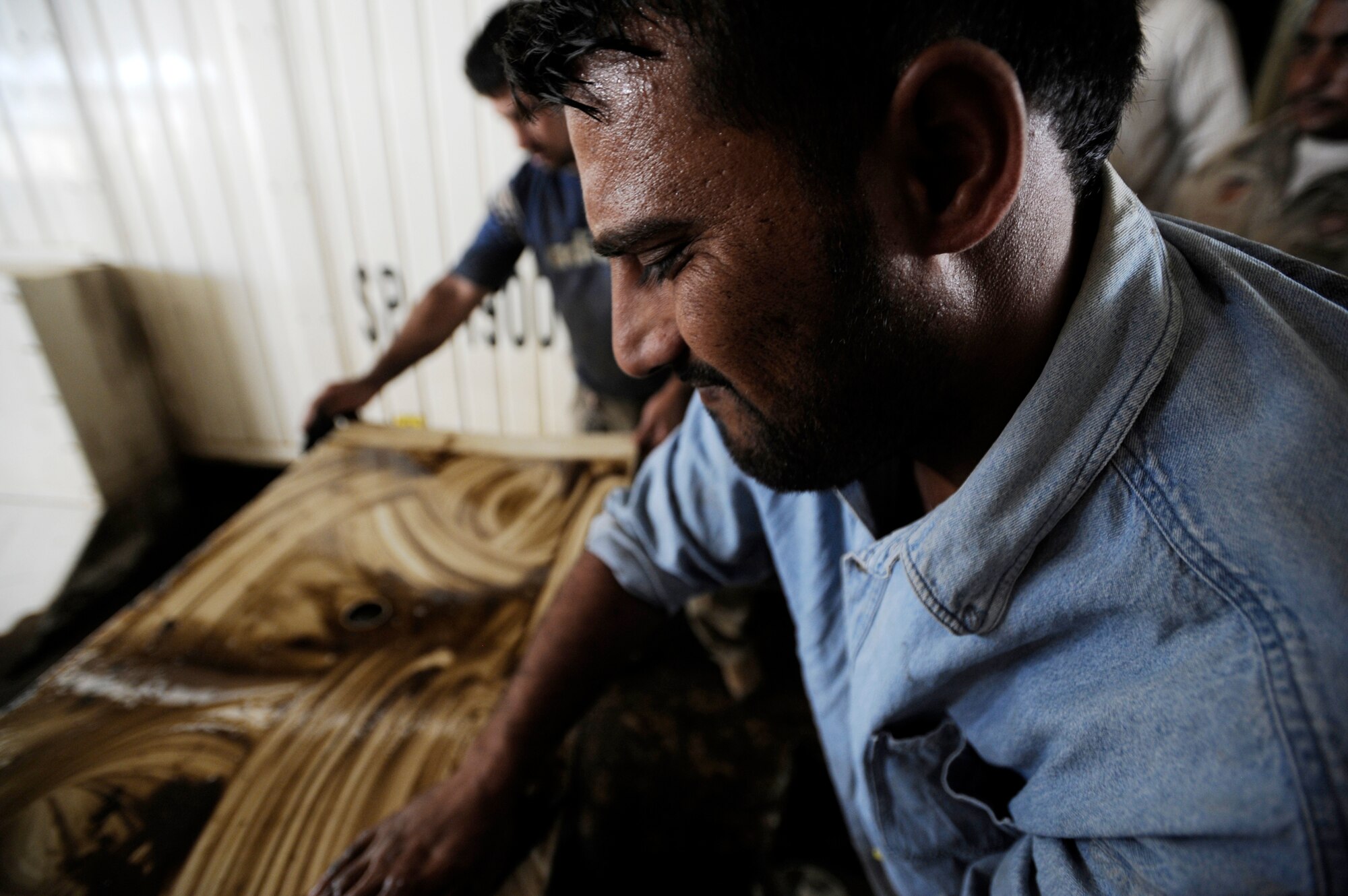 Iraqi contractors work on a generator that powers Camp Ur, an Iraqi military base, on the outskirts of An Nasariyah Aug. 17, 2009. (U.S. Air Force photo/Staff Sgt. Shawn Weismiller) 