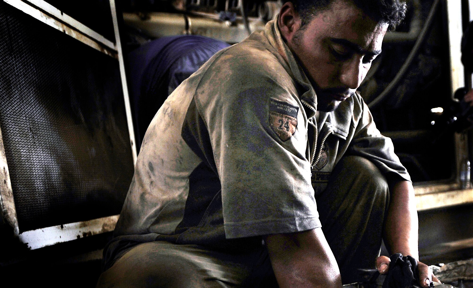 An Iraqi contractor works on a generator that helps power Camp Ur, an Iraqi military base, near the city of An Nasiriyah Aug. 17, 2009. Camp Ur is supported by members of the Tallil Logistics Military Advisory Team who advise the Iraqis on base operations. (U.S. Air Force photo/Staff Sgt. Shawn Weismiller) 