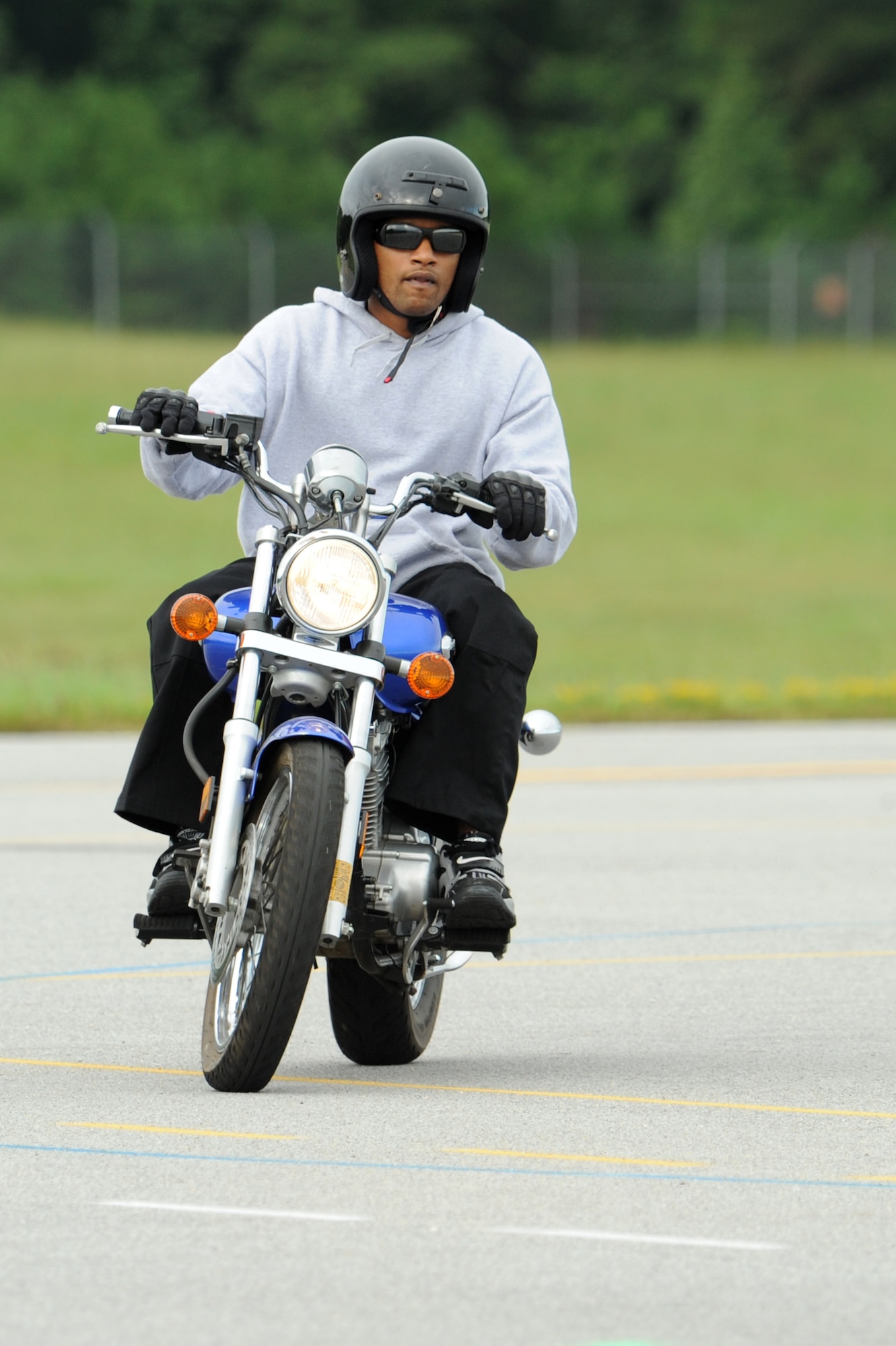 Airman 1st Class Brian Delacruz, 4th Force Support Squadron food service apprentice, learns how to ride a motorcycle during the Basic Rider's Course on Seymour Johnson Air Force Base, N.C., Sept. 1, 2009. The course is mandatory for all Air Combat Command servicemembers and Department of Defense civilians to ride a motorcycle on and off base. (U.S. Air Force photo by Airman 1st Class Whitney Lambert)