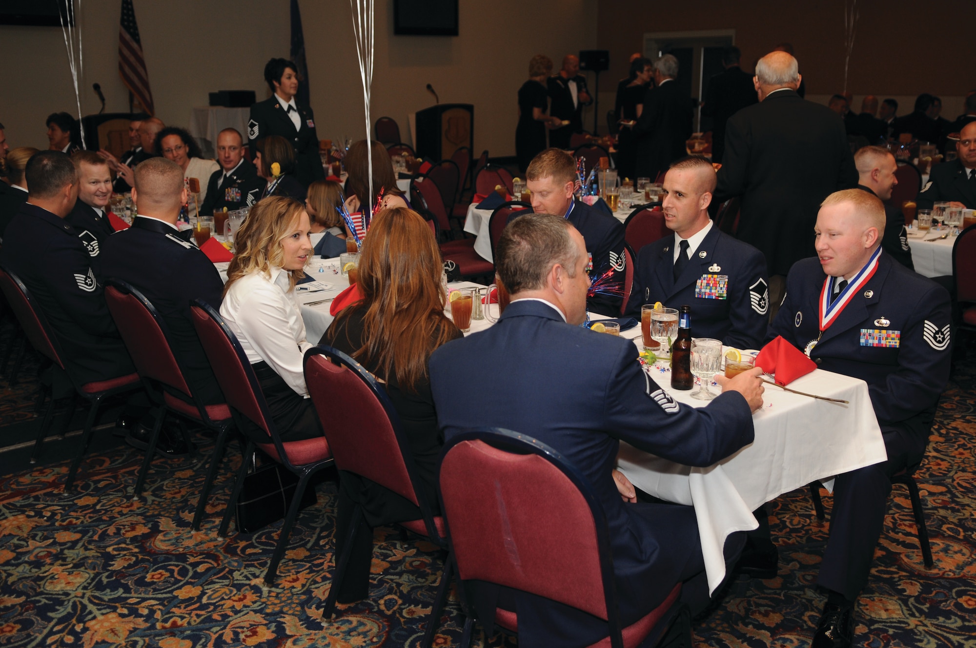 Promotees and guests enjoy dinner and conversation at the SNCO Induction Ceremony. (U.S. Air Force photo by Tech. Sgt. John Barton).
