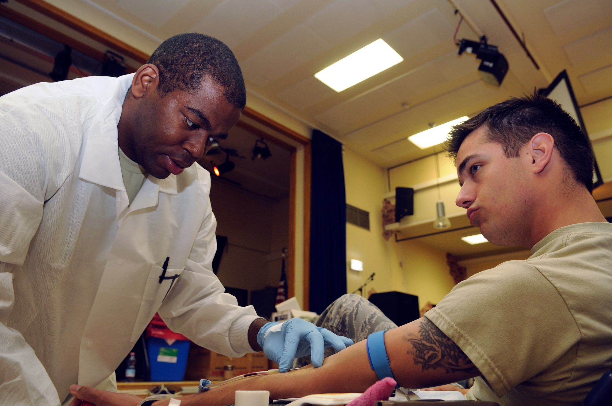 SPANGDAHLEM AIR BASE, Germany – Spc. Toby Johnson, Armed Services Blood Bank Center – Europe, draws blood from, donor, Airman 1st Class Thomas Lewis, 52nd Equipment Maintenance Squadron, during a blood drive held at the Brick House in the community center Sept. 2. The blood drive had 71 donors, totaling 55 whole units of blood. Each unit collected can potentially save three lives. (U.S. Air Force photo/Senior Airman Benjamin Wilson)
