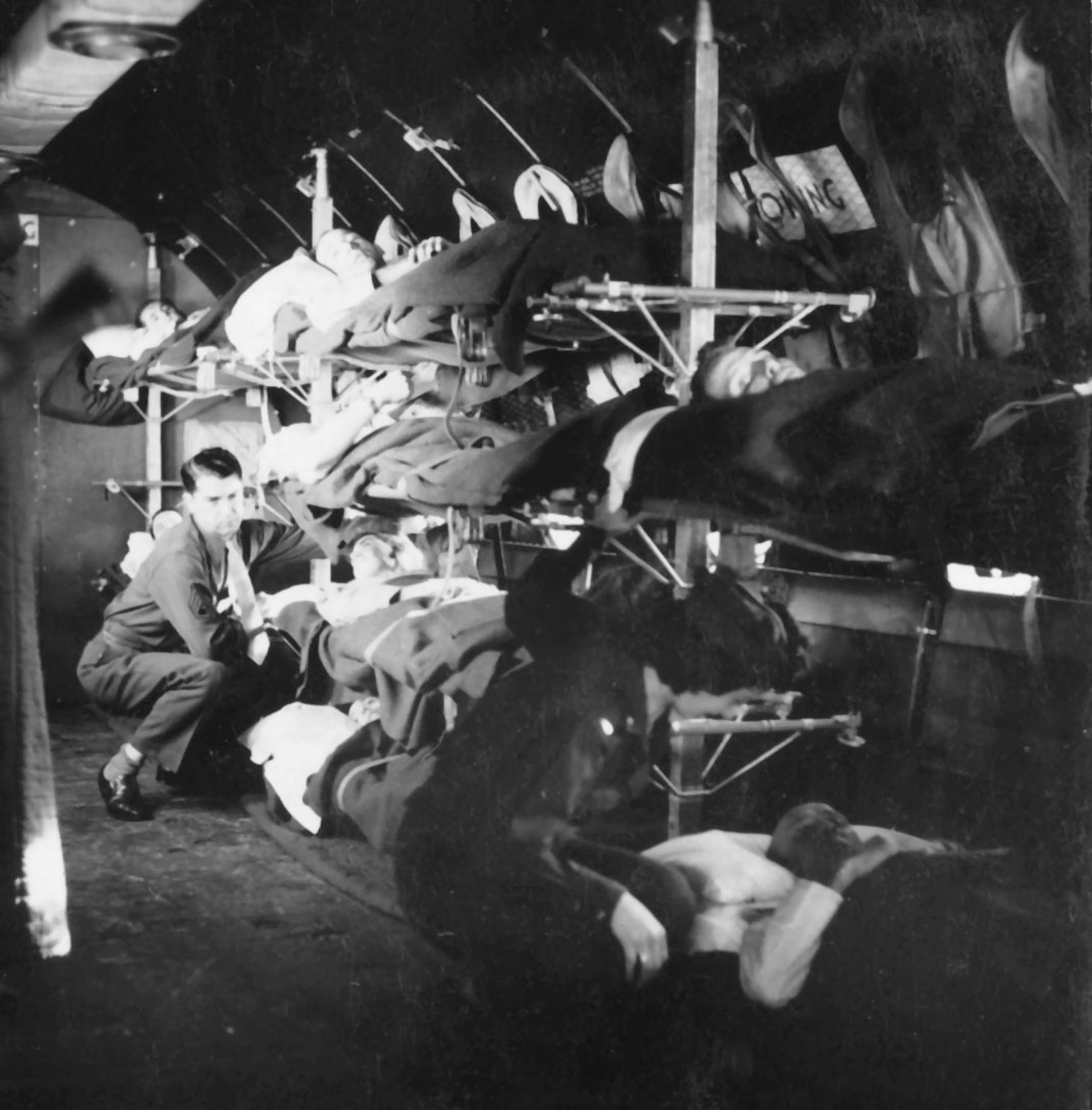 A medical technician and a flight nurse (lower right corner) tend to patients on a C-54 aircraft. The C-54 allowed larger numbers of patients to be air evacuated great distances. (Photo courtesy AFRL Research Division)